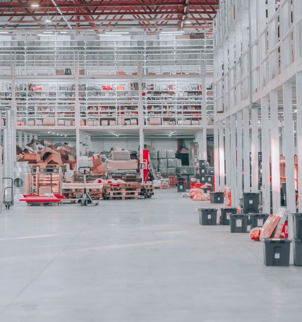 Large, white and red warehouse with various boxes and pallets